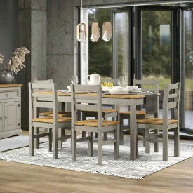 Dining room setting with a 6 seater dining table and chairs, in pine and grey washed finish.