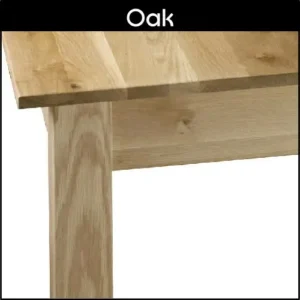 Close up of the corner of an oak dining table.