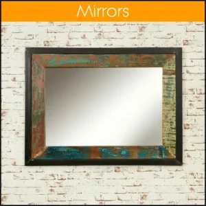 A large wall mirror with a multicoloured reclaimed wood frame, hanging on a whitewashed brick wall.