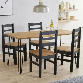 A pine and black 4 place dining set, ready to go in a kitchen.