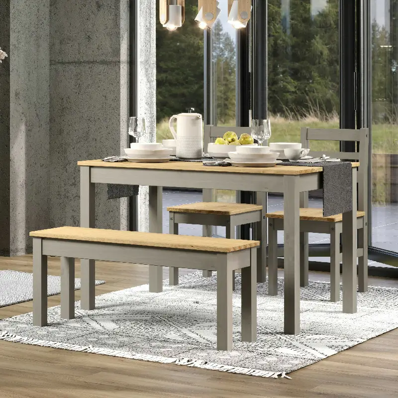 CRGTB6set2-1 Large dining table with a bench seat at one side and 2 chairs at the other side. It's sitting in the corner of a room with lots of natural light coming through floor to ceiling windows.